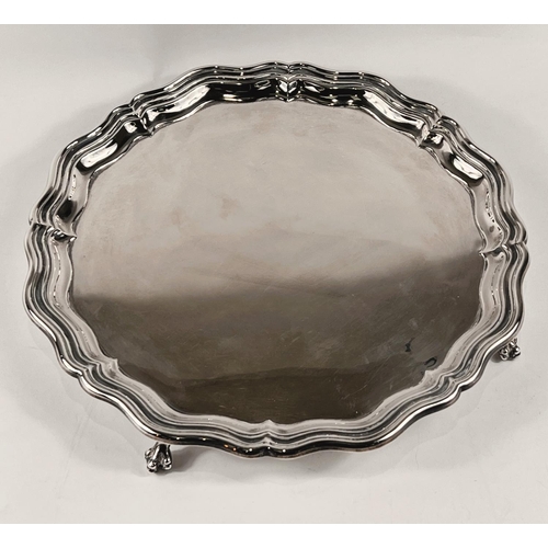 809 - A hallmarked silver circular salver, Georgian style with wavy moulded rim, on 4 ball and claw feet, ... 