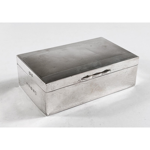 818 - A hallmarked silver rectangular cigarette box, engine turned, Birmingham 1953