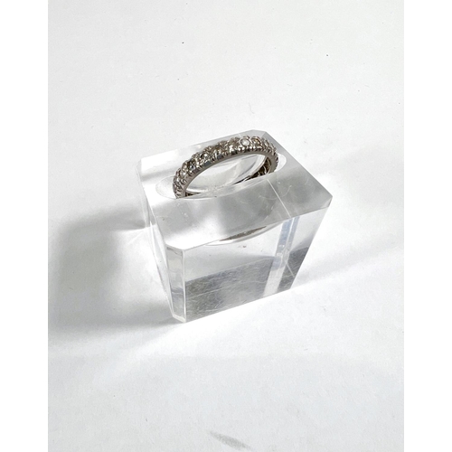 827 - A white metal eternity ring with diamonds in illusion settings, size L, gross 3.3gm