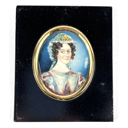 840 - An early 19th century 1/2 length miniature portrait of a woman with a floral lace bonnet on ivory pa... 