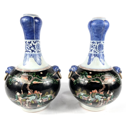 411A - A pair of Chinese Famille Noir vases with blue and white highlights, traditional scenes with 6 chara... 