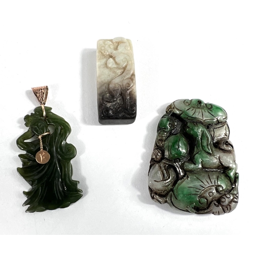 440A - Three Chinese jade coloured hard stone items: One carved belt loop and two pendants, one mounted in ... 