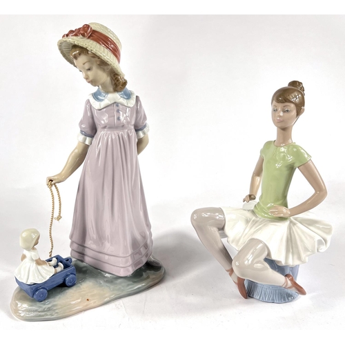 478 - Two Lladro figures:  girl with pull-along doll, No 5044, height 28cm; a seated ballerina B-18D