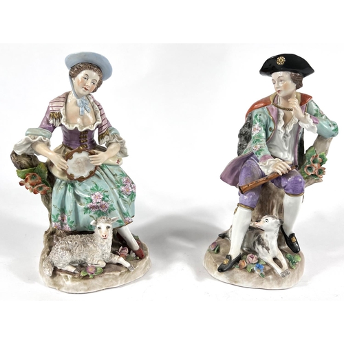 482 - A pair of Sitzendorf figures in 18th century dress:  boy with flute and dog, girl with tambouri... 