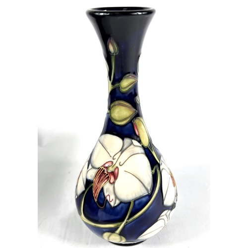 496B - A modern Moorcroft baluster vase with long flared neck, decorated with 'Chatsworth Orchid', against ... 