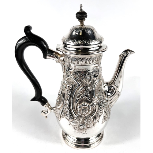 633 - A Georgian style hallmarked silver coffee opt of baluster form with domed lid, extensive scroll and ... 