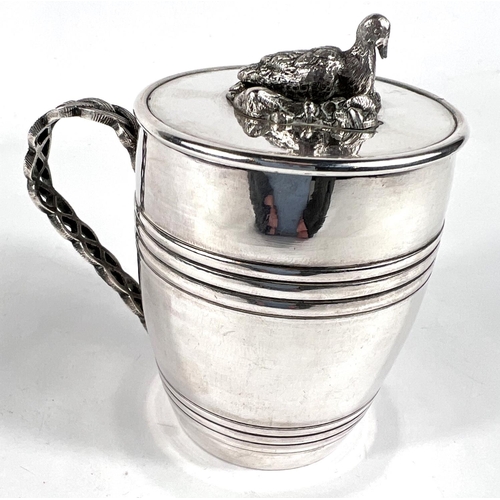 704 - An unusual Middle Easten white metal covered mug in the form of a barrel with sitting duck finial, p... 