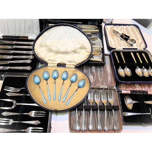 754 - A cased set of silver gilt and blue enamel coffee spoons; a cased set of 6 tea knives stamped 