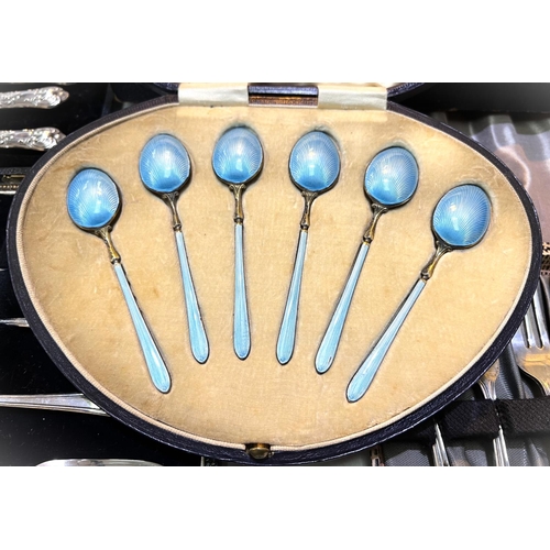 754 - A cased set of silver gilt and blue enamel coffee spoons; a cased set of 6 tea knives stamped 