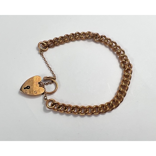 654 - A 9 carat hallmarked gold curb link bracelet with 9 carat hallmarked gold heart lock, 23.75gm