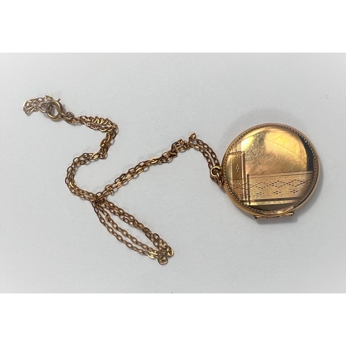 663 - An engine turned circular locket stamped '9ct', on fine chain, 5.7gm