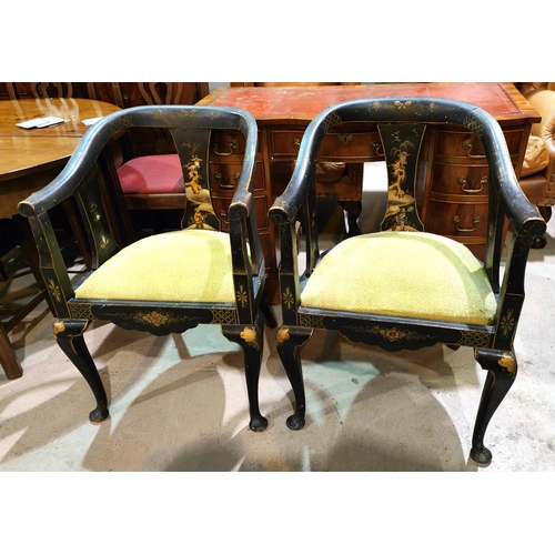 1008 - A Chinese pair of tub chairs decorated iin black & gilt with flowers and traditional scenes