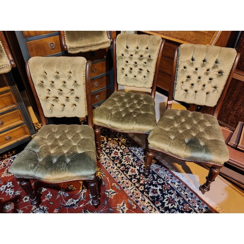 1037 - A set of six early 19th century dining chairs with deeply button back green upholstery, carved taper... 