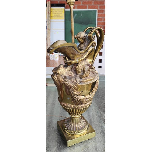 1055 - A brass jug lamp with ocean decoration in the form of Poseidon, with fish spout