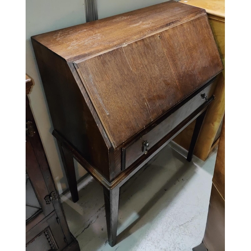 1062 - A Jacobean style oak glazed books case and an oak bureau