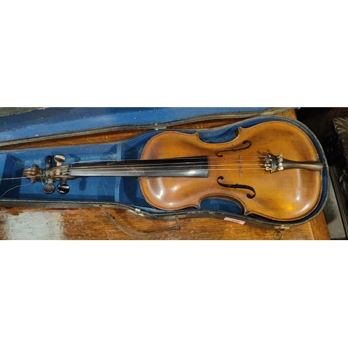 339 - A late 19th early 20th century two piece back violin, stamped Stainer to the reverse, with scrolling... 