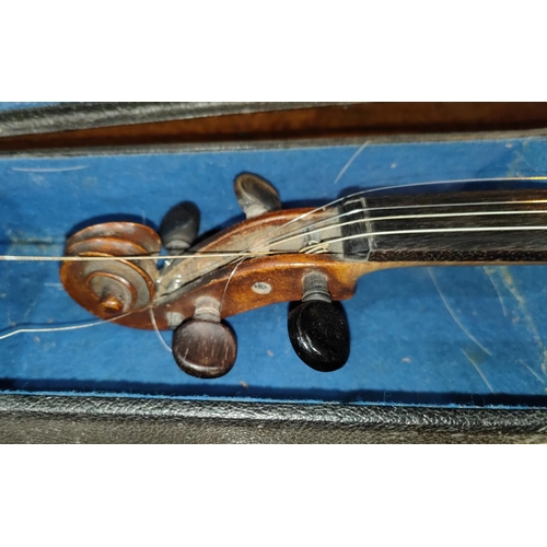 339 - A late 19th early 20th century two piece back violin, stamped Stainer to the reverse, with scrolling... 