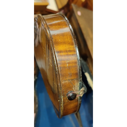 339 - A late 19th early 20th century two piece back violin, stamped Stainer to the reverse, with scrolling... 