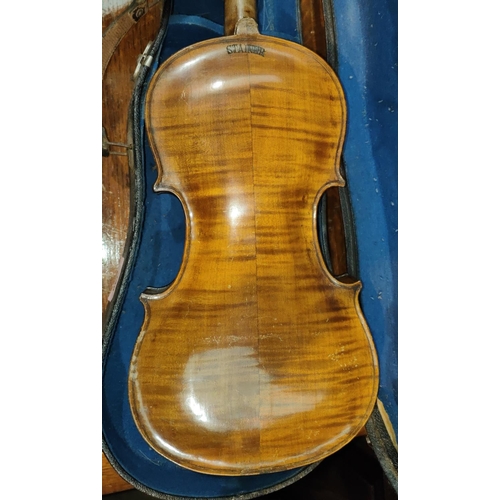 339 - A late 19th early 20th century two piece back violin, stamped Stainer to the reverse, with scrolling... 