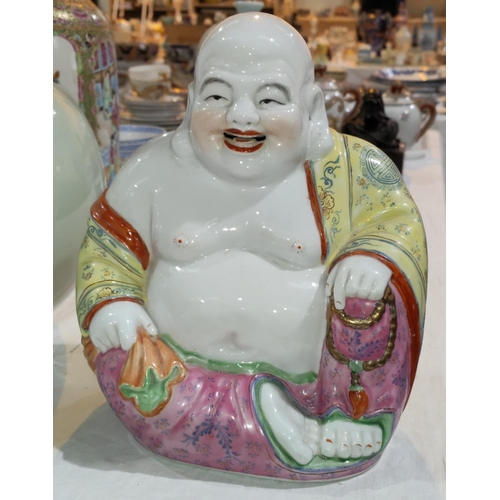 349A - A Chinese Republic period porcelain figure of Ho Tai in seated position, with impressed seal mark to... 