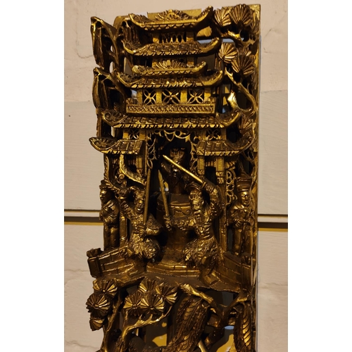 449 - A Chinese carved and pierced gilt wood wall hanging decoration, wit warriors fighting below a temple... 