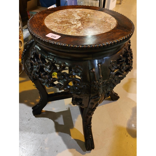 459 - A Chinese carved and pierced wooden occasional table/ vase stand, with central marble piece floral d... 