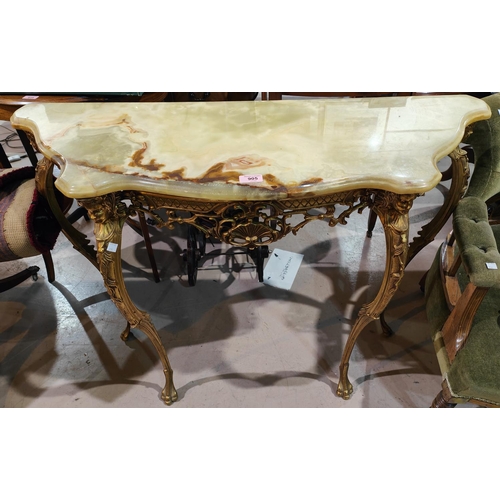 905 - A period style side table in ornate gilt metal with onyx top; similar mirror