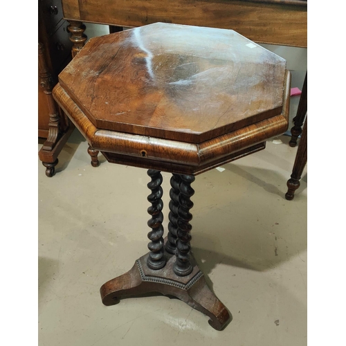 973 - A Victorian rosewood octagonal work table with inlaid and fitted interior, on triple barley twist le... 