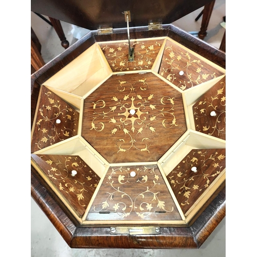 973 - A Victorian rosewood octagonal work table with inlaid and fitted interior, on triple barley twist le... 