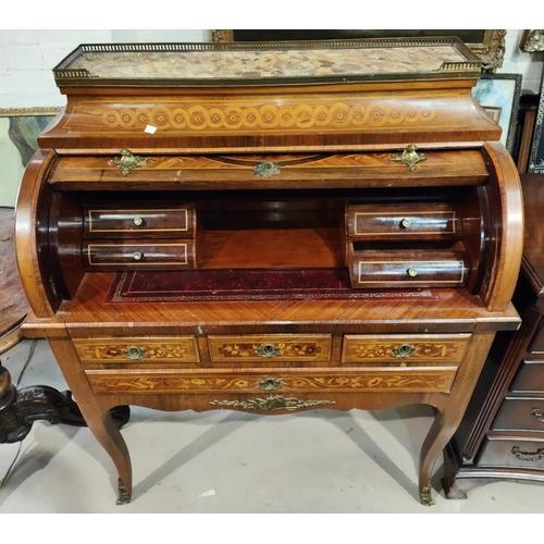 974 - A late 19th/early 20th century cylinder bureau in the Louis XVI manner, in marquetry with galleried ... 