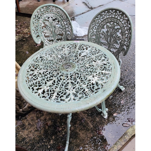 989 - A Victorian style cast metal garden table and 2 chairs