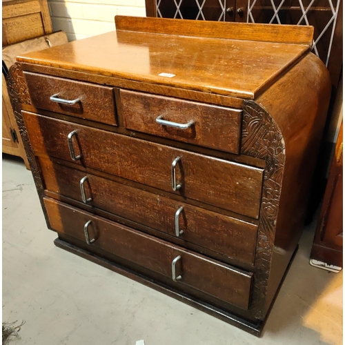 1023 - An Art Deco oak shaped chest of 3 long and 2 short drawers with chrome hooped handles, incised decor... 