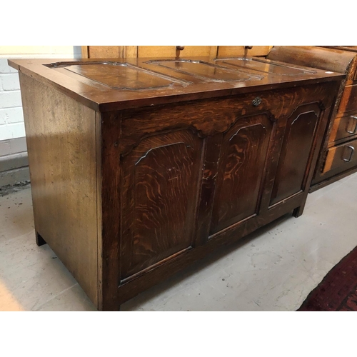 1027 - A golden oak panel front chest with hinged lid etc 115 x 55 x 69cm