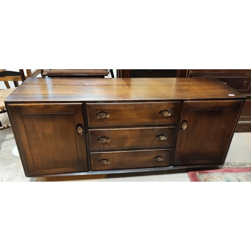 1030 - An Ercol sideboard of double cupboard and 3 drawers in dark finish length 155 x d.46 x ht 68cm