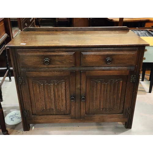 1034 - An oak reproduction Jaycee side cabinet with double panel fold doors, two drawers, l. 106 x d. 43 x ... 