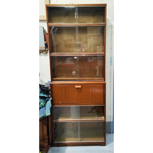 1035 - A mid century stacking bookcase unit with 5 sliding glass sections and a fall front section with fit... 