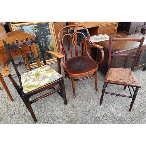 1046 - A 1930's bent wood arm chair with decorated seat and looping upright support, an Ercol arm chair and... 