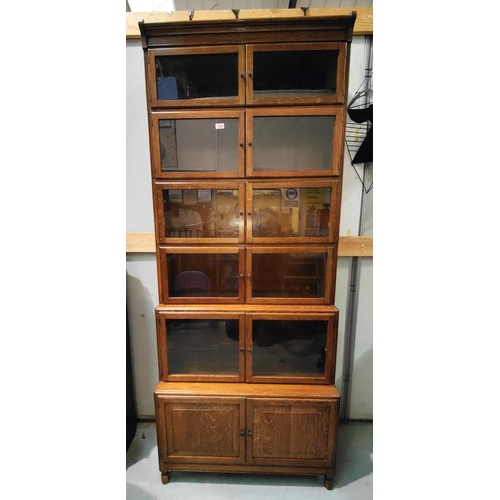 1050 - A tall oak Globe Wernick style academic stacking bookcase of five double door glazed sections and a ... 