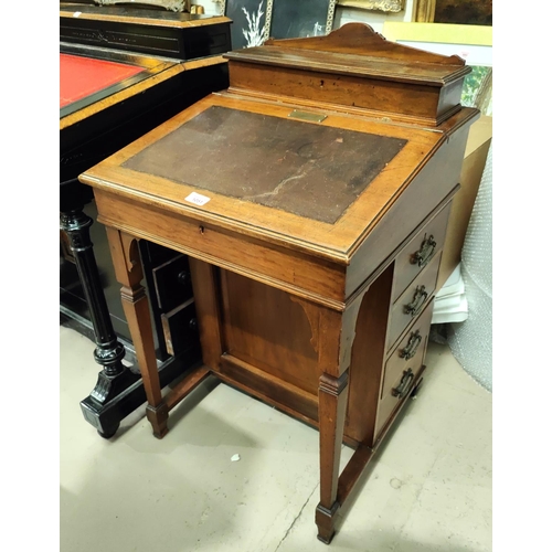 1051 - An oak davenport with sloped writing front drawers to the side, two interior drawers and letter rack... 