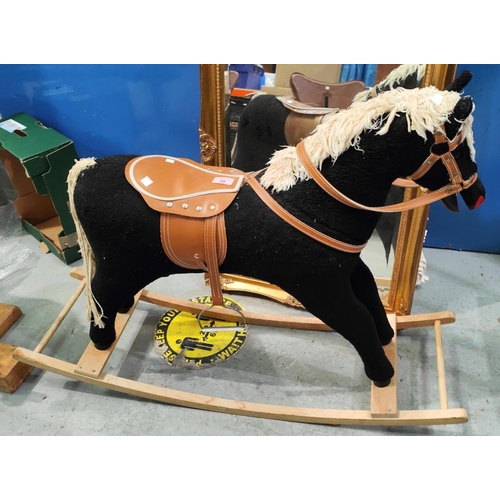 20 - A modern rocking horse, black fur effect body, cream wool mane and tail with leather effect saddle