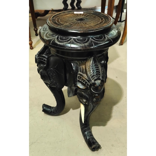 441 - An Asian carved elephant head vase/jardiniere stand, the legs being the elephants trunks, height 57c... 