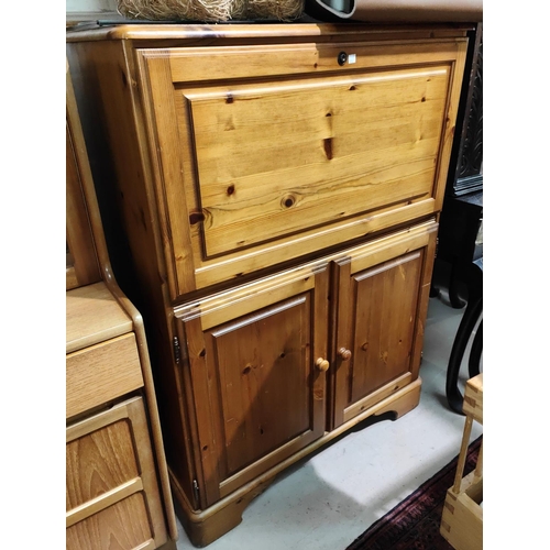 898 - A modern pine side cabinet with fall front upper section and double cupboard below