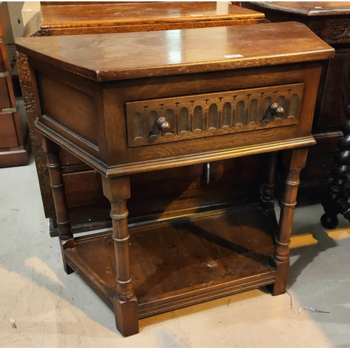 908 - A reproduction 'credence' tale in distressed oak, with canted front and frieze drawer, on turned leg... 