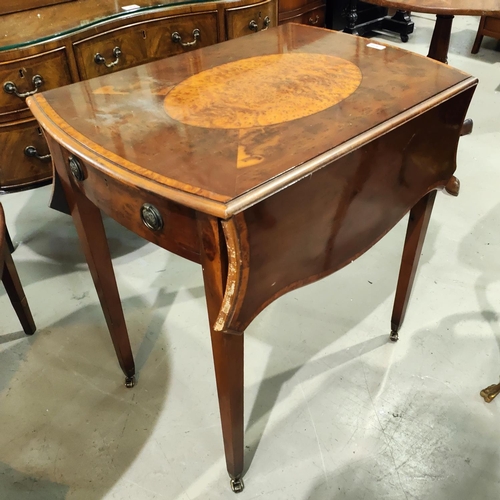 910 - A reproduction Regency Pembroke table in crossbanded yew wood, with inlaid oval top and frieze drawe... 