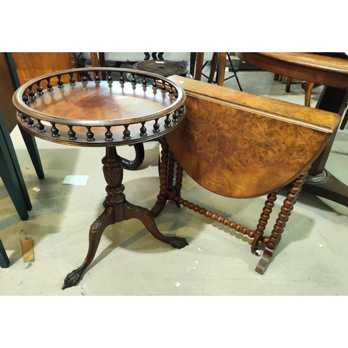 913 - A reproduction mahogany wine table with circular galleried top, on turned and carved column and base... 