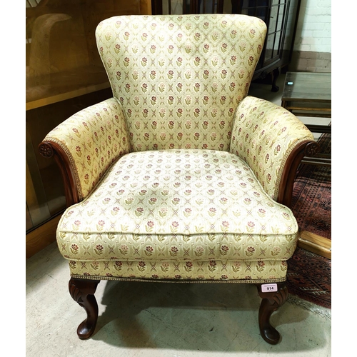 914 - A mid 20th century period style mahogany armchair on carved cabriole legs, in floral brocade upholst... 