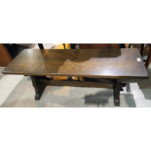 917 - A period style oak coffee table with rectangular top, on stretcher and peg base