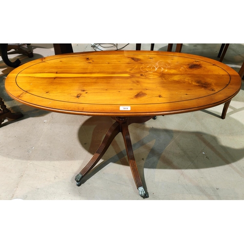 919 - A nest of 3 yew wood trio tables; a similar oval coffee table