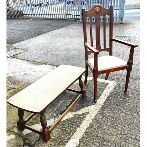 938 - An oak traditional style coffee table with carved legs, a 1930's oak armchair with tapering legs