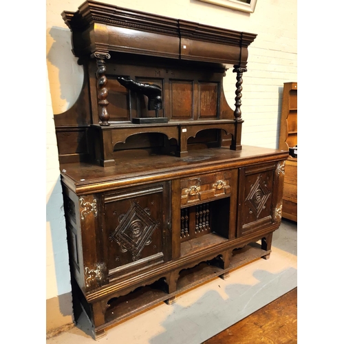 959 - A 19th century Jacobean style large dresser with raised panel back, 2 carved end cupboards, central ... 